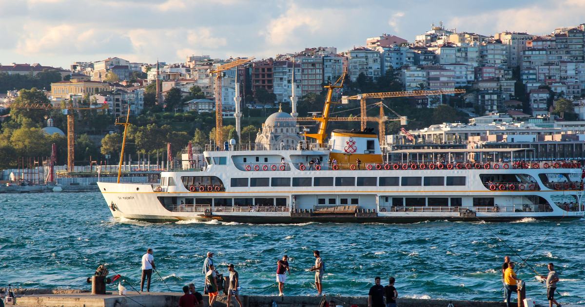 A ferry on the Bosphorus in front of Istanbul's hillside neighbourhoods